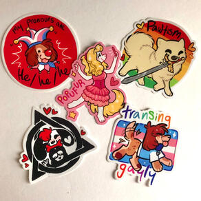 A set of five stickers on a white background. The first is a circular red sticker with a white border. A silly jester dog (my fursona) with trans flag colored jester hat with bells, clown collar, and a round red clown nose sticks his tongue out at the vi