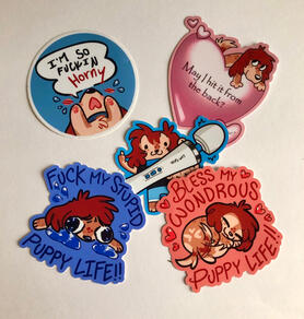 A picture of five sticker designs on a white background! The first is a round sticker with a blue background and white border. An orange and red cartoon dog (my fursona) throws his paws up in the air and yells “I’M SO HORNY” while blushing and crying. Th