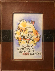 A watercolor of a dog in a brown and black leather frame. He is colored yellow and orange. His eyes are closed in pleasure and his tongue is out. He has a whiskery nose. The background is a gentle lavender cloud. The caption reads: "I AM HAPPY BECAUSE I LO